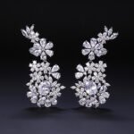 Wholesale floral zircon earrings with clear cubic zirconia petals on platinum plated brass from JuneJewelry.com – bridal chandelier drop earrings for bulk purchase.