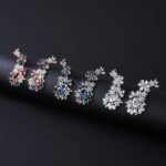 Wholesale floral zircon earrings with clear cubic zirconia petals on platinum plated brass from JuneJewelry.com – bridal chandelier drop earrings for bulk purchase.