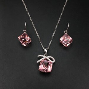 Wholesale bow jewelry set made of white gold plated copper with pink Swarovski element crystals and ribbon bow accents from JuneJewelry.com.