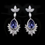 Wholesale teardrop crystal earrings with dark blue Swarovski Element crystals on platinum plated brass from JuneJewelry.com – statement dangle earrings for bulk purchase.