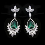 Wholesale teardrop crystal earrings with dark blue Swarovski Element crystals on platinum plated brass from JuneJewelry.com – statement dangle earrings for bulk purchase.