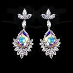 Wholesale teardrop crystal earrings with dark blue Swarovski Element crystals on platinum plated brass from JuneJewelry.com – statement dangle earrings for bulk purchase.