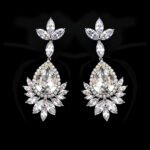 Wholesale teardrop crystal earrings with dark blue Swarovski Element crystals on platinum plated brass from JuneJewelry.com – statement dangle earrings for bulk purchase.