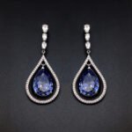 Wholesale waterdrop crystal earrings with blue Swarovski Element crystals in platinum plated brass from JuneJewelry.com – luxury dangle earrings for bulk orders.