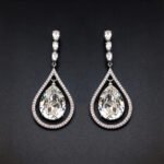 Wholesale waterdrop crystal earrings with blue Swarovski Element crystals in platinum plated brass from JuneJewelry.com – luxury dangle earrings for bulk orders.