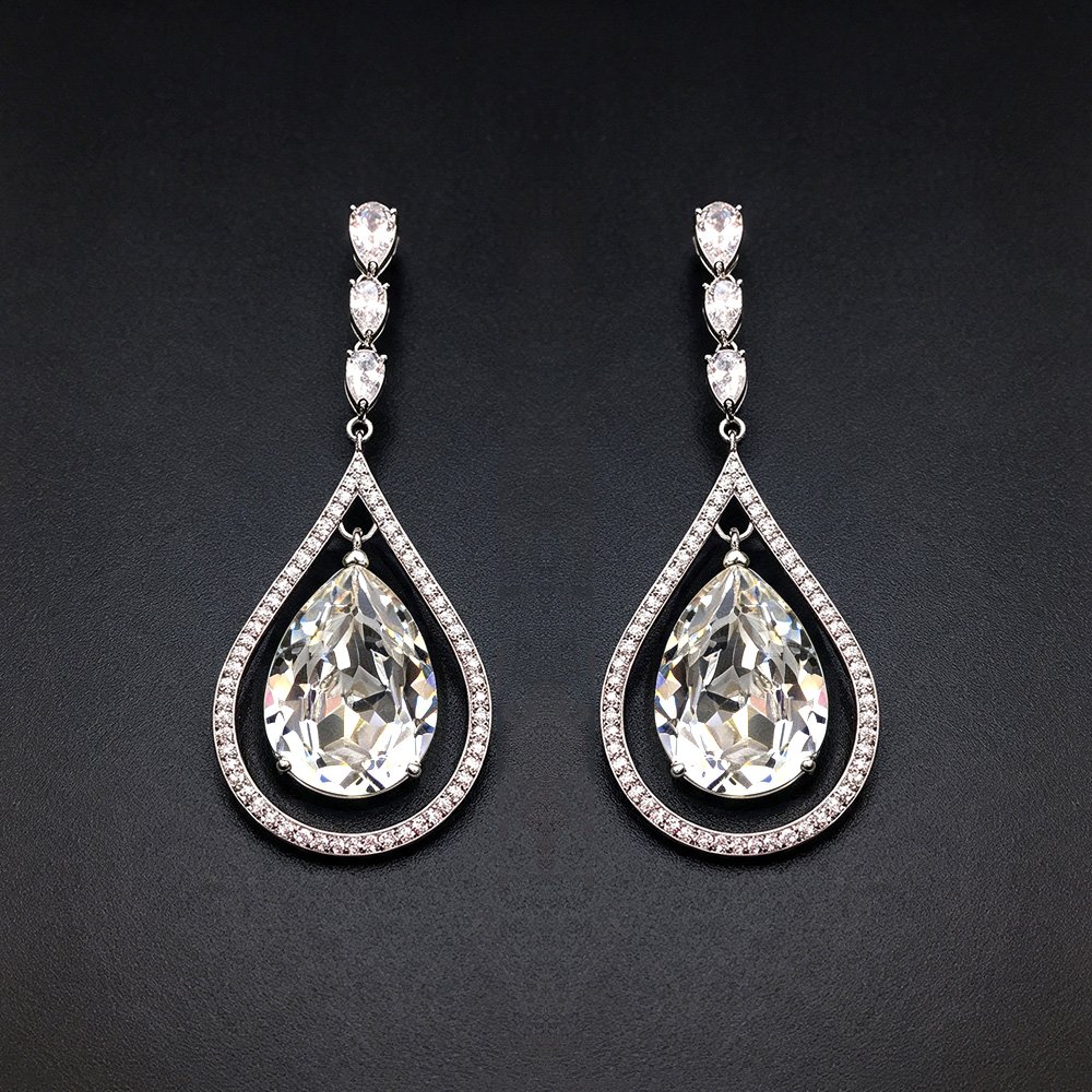 Wholesale waterdrop crystal earrings with blue Swarovski Element crystals in platinum plated brass from JuneJewelry.com – luxury dangle earrings for bulk orders.