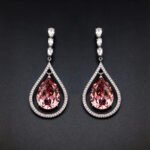 Wholesale waterdrop crystal earrings with blue Swarovski Element crystals in platinum plated brass from JuneJewelry.com – luxury dangle earrings for bulk orders.