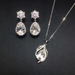 Wholesale crystal jewelry set featuring white gold plated copper with magenta pink teardrop Swarovski element crystals from JuneJewelry.com.