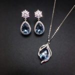 Wholesale crystal jewelry set featuring white gold plated copper with magenta pink teardrop Swarovski element crystals from JuneJewelry.com.