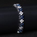Wholesale Floral Zircon Bracelet featuring four-petal flower CZ stones on platinum plated copper from JuneJewelry.com