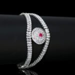 Wholesale Crystal Bangle Bracelet featuring double row baguette stones and red sunburst halo on platinum plated copper from JuneJewelry.com.