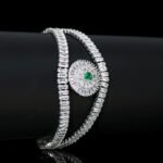 Wholesale Crystal Bangle Bracelet featuring double row baguette stones and red sunburst halo on platinum plated copper from JuneJewelry.com.