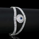 Wholesale Crystal Bangle Bracelet featuring double row baguette stones and red sunburst halo on platinum plated copper from JuneJewelry.com.