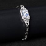 Wholesale Radiant Zircon Bracelet with cushion-cut main stone and filigree halo on platinum plated copper from JuneJewelry.com.