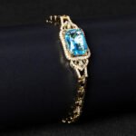 Wholesale Radiant Zircon Bracelet with cushion-cut main stone and filigree halo on platinum plated copper from JuneJewelry.com.