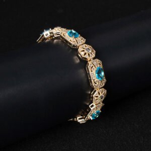 Wholesale Royal Zircon Bracelet featuring aqua blue gemstones in milgrain gold plated copper from JuneJewelry.com.