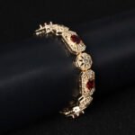 Wholesale Royal Zircon Bracelet featuring aqua blue gemstones in milgrain gold plated copper from JuneJewelry.com.