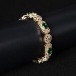 Wholesale Royal Zircon Bracelet featuring aqua blue gemstones in milgrain gold plated copper from JuneJewelry.com.