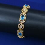 Wholesale Royal Zircon Bracelet featuring aqua blue gemstones in milgrain gold plated copper from JuneJewelry.com.