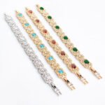 Wholesale Royal Zircon Bracelet featuring aqua blue gemstones in milgrain gold plated copper from JuneJewelry.com.