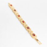 Wholesale Royal Zircon Bracelet featuring aqua blue gemstones in milgrain gold plated copper from JuneJewelry.com.