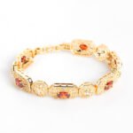 Wholesale Royal Zircon Bracelet featuring aqua blue gemstones in milgrain gold plated copper from JuneJewelry.com.