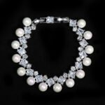 Wholesale Square Pearl Bracelet featuring princess-cut CZ stones and shell pearls on platinum plated copper from JuneJewelry.com