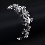 Wholesale Wave Zircon Bracelet featuring paved wave links and solitaire CZ gems on platinum plated copper from JuneJewelry.com