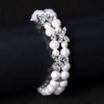Wholesale Pearl Zircon Bracelet featuring double-strand pearls and CZ flower connectors on platinum plated copper from JuneJewelry.com