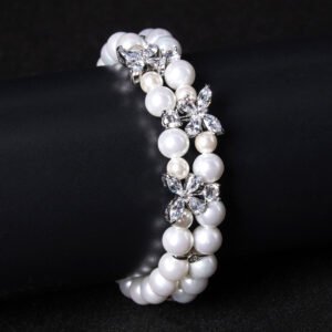 Wholesale Pearl Zircon Bracelet featuring double-strand pearls and CZ flower connectors on platinum plated copper from JuneJewelry.com