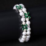 Wholesale Pearl Zircon Bracelet featuring double-strand pearls and CZ flower connectors on platinum plated copper from JuneJewelry.com
