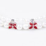 Wholesale Pearl Zircon Bracelet featuring double-strand pearls and CZ flower connectors on platinum plated copper from JuneJewelry.com