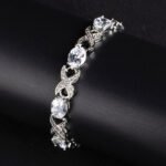 Wholesale Infinity Zircon Bracelet featuring oval CZ gems and paved cross links on platinum plated copper from JuneJewelry.com