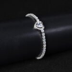 Wholesale Heart Zircon Bracelet featuring a paved heart centerpiece on a tennis chain with platinum plated copper from JuneJewelry.com