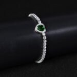 Wholesale Heart Zircon Bracelet featuring a paved heart centerpiece on a tennis chain with platinum plated copper from JuneJewelry.com