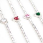 Wholesale Heart Zircon Bracelet featuring a paved heart centerpiece on a tennis chain with platinum plated copper from JuneJewelry.com