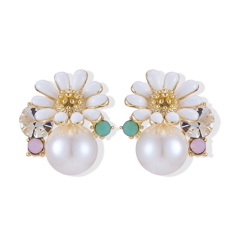 Gold-plated flower stud earrings featuring a white enamel daisy blooming over a smooth faux pearl, accented with a faceted crystal, turquoise bead, and lavender stone.