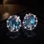 Maple leaf oval cubic zirconia stud earrings with micro-paved scalloped halo border and 925 sterling silver posts