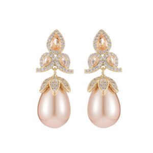 Tear-shaped pearl drop earrings featuring three teardrop crystal clusters top and micro-pavé cap accents, available in gold and palladium plating.