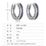 Sapphire blue huggie hoop earrings featuring channel-set princess-cut blue cubic zirconia, side filigree lattice detailing, and platinum plating.