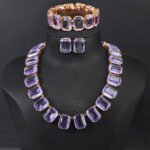Crystal statement jewelry set wholesale including emerald-cut crystal collar necklace, matching stud earrings, and link bracelet in 18K gold and palladium plated copper.