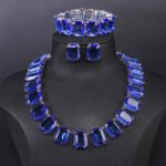Crystal statement jewelry set wholesale including emerald-cut crystal collar necklace, matching stud earrings, and link bracelet in 18K gold and palladium plated copper.