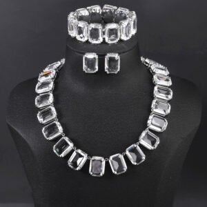 Crystal statement jewelry set wholesale including emerald-cut crystal collar necklace, matching stud earrings, and link bracelet in 18K gold and palladium plated copper.