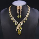 Leopard CZ jewelry set wholesale featuring 3D sculpted panther leopard motifs, tear-drop cubic zirconia stones, statement necklace, and long dangle earrings on 18K gold and palladium plated copper.