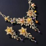 Wholesale Lily Pearl Set featuring CZ lily flowers and vine branch drops with multicolored shell pearls on gold plated copper from JuneJewelry.com – SKU CN11471.909.A.