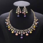 Wholesale Lace Pearl Set featuring CZ paved openwork heart loops with dangling colorful shell pearls on gold plated copper from JuneJewelry.com.
