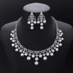 Wholesale Lace Pearl Set featuring CZ paved openwork heart loops with dangling colorful shell pearls on gold plated copper from JuneJewelry.com.