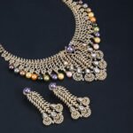 Wholesale Feather Pearl Set featuring a CZ leaf bib necklace with dangling colorful shell pearls on gold plated copper from JuneJewelry.com.
