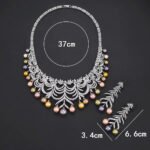 Wholesale Arch Pearl Set featuring a CZ arched leaf bib necklace with dangling colorful shell pearls on gold plated copper from JuneJewelry.com.