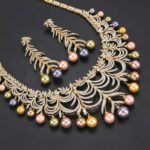 Wholesale Arch Pearl Set featuring a CZ arched leaf bib necklace with dangling colorful shell pearls on gold plated copper from JuneJewelry.com.